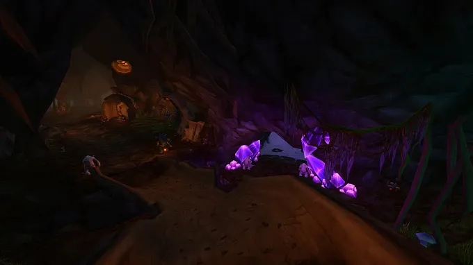 WoW Forever Barrow Deeps Raid showing some small houses inside the mountain, enemies walking aorund the area, purple shiny rocks on the side, and a small passage leading deeper into the dungeon