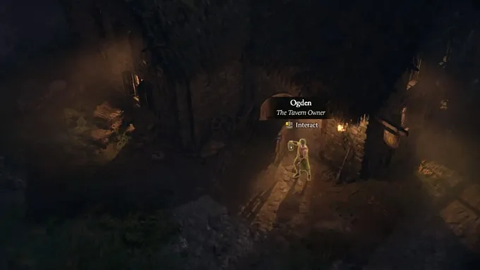 Diablo 4 gameplay showing Ogden, the Tavern Owner, standing outside a building in Old Tristram at night.