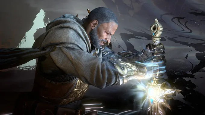 Tyrael from Diablo 4, in a grey hooded cloak and ornate gold gauntlets, kneels and grips his glowing sword as dark shadowy tendrils swirl behind him.